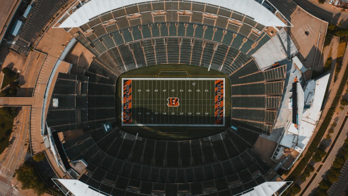 MLSZ és klub-finanszírozás: tulajdonosi szerkezet — From above drone view of empty American football stadium with white lines and em
