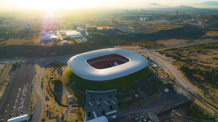 Sport közbeszerzések: RRF-érintettség — Captivating aerial shot of Estadio Akron in Zapopan, Mexico during sunset.