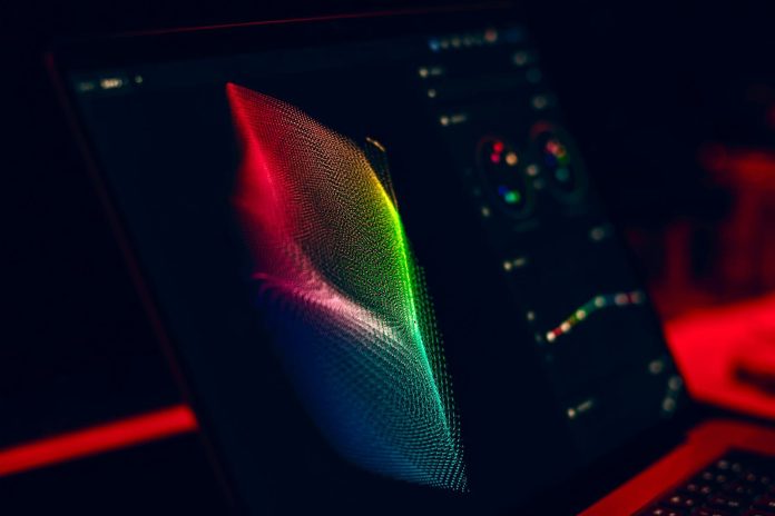 Infografika riport: regionális összevetés — Close-up of vibrant digital art in red, green, and blue displayed on a monitor s