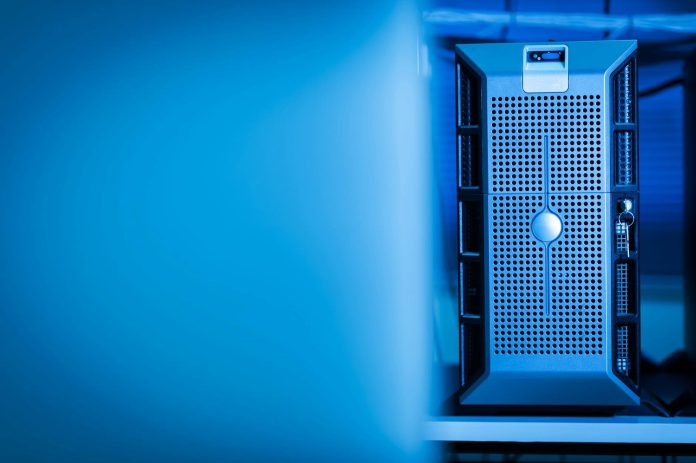 Digitális állam: EU-szabályozói feltételek — Close-up of a modern server unit in a blue-lit data center environment.