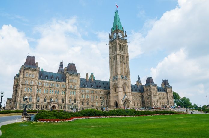 Tisza-kormány intézkedései: iparági konszolidáció — Stunning photo of Canada's Parliament Hill in Ottawa under a clear sky, showcasi