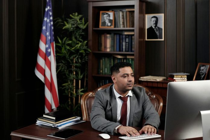 Új politikai korszak után: mi vár a 2010-ben épült magyar gazdasági elitre 2026 áprilisa után? — A confident businessman works at his desk with an Ame